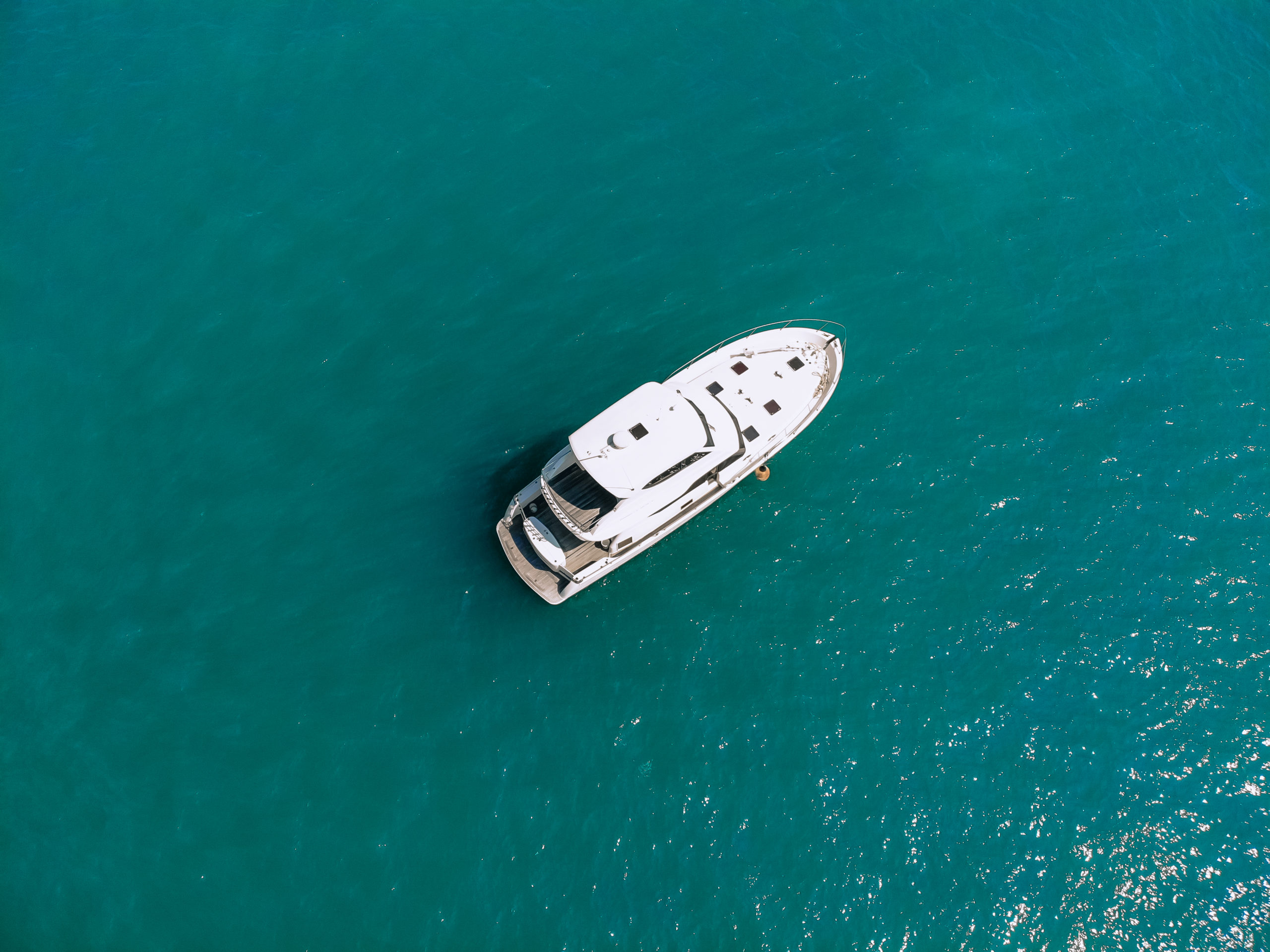 Awesome aerial top view photo of a laxury enormous two-storey yach sailing across the deer sea
